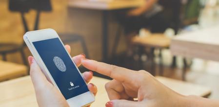 Hand women holding smartphone and scan fingerprint biometric identity for unlock her mobile phone