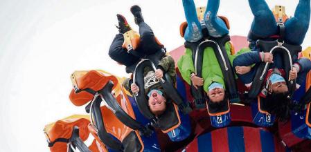 Visitors ride attractions on the opening day of the 2021 season at the Luna Park amusement park in Coney Island, New York on April 9, 2021. - After 18 months of closure due to the coronavirus pandemic, Coney Island's amusement parks reopened Friday with limited capacity and new Covid-19 guidelines. (Photo by Ed JONES / AFP)