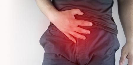 Man front view. Pain in the groin and bladder. The concept of pain in men as a result of prostatitis, inflammation of the bladder or genitourinary system. Frequent urination. (Man front view. Pain in the groin and bladder. The concept of pain in men a