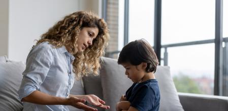Latin American boy at home having a tantrum at home and mother trying to talk to him - lifestyle concepts