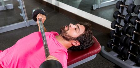 Barbell inclined bench Press flyes man exercise workout at gym