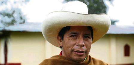 Free Peru party presidential candidate Pedro Castillo poses for a photo on his land in Chugur, Peru, Friday, April 16, 2021. Castillo, a rural teacher, who has proposed rewriting Peru's constitution and deporting all immigrants living in the country illegally, will face rival candidate Keiko Fujimori in the June 6 presidential run-off election. (AP Photo/Martin Mejia)