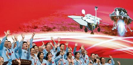 In this photo released by Xinhua News Agency, members at the Beijing Aerospace Control Center celebrate after China's Tianwen-1 probe successfully landed on Mars, at the center in Beijing, Saturday, May 15, 2021. China landed a spacecraft on Mars for the first time on Saturday, a technically challenging feat more difficult than a moon landing, in the latest advance for its ambitious goals in space. (Jin Liwang/Xinhua via AP)