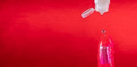 Seductive banner for sex store. Lubricant and dildo.