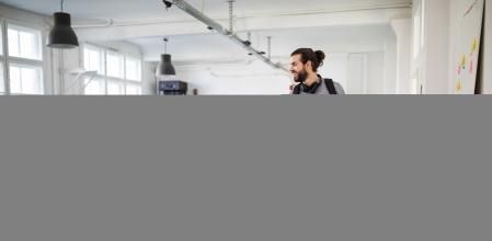 Businessman with a bicycle in office. Business professional going home after work.