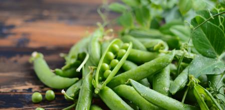Guisantes sobre mesa de madera