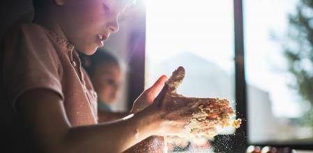 Toddler boy and girl are preparing food in kitchen. Food preparation at home during COVID-19 isolation.