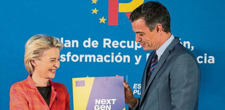 EU Commission President Ursula von der Leyen, left, and Spain's Prime Minister Pedro Sanchez hold the Next Gen EU agreement during a press conference in Alcobendas, outskirts of Madrid, Spain, Wednesday, June 16, 2021. (AP Photo/Bernat Armangue, Pool)