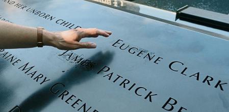DÃ©sirÃ©e Bouchat reaches towards the inscribed name of James Patrick Berger at the National September 11 Memorial, Friday, Aug. 6, 2021, in New York. She last saw her co-worker on the 101st floor of the trade center's south tower. Nearly 180 Aon Corp. workers perished on Sept. 11, 2001, including Berger. â#{emoji}128;#{emoji}156;Some days, it feels like it happened yesterday,â#{emoji}128;#{emoji}157; Bouchat says. (AP Photo/Mark Lennihan)
