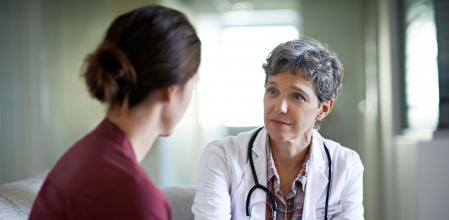 Shot of a compassionate doctor comforting a young woman in a hospital waiting room