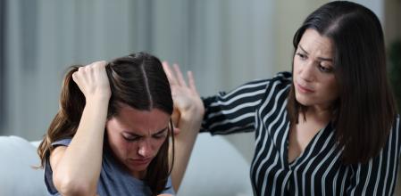 Sad teen rejecting help from her sister at home