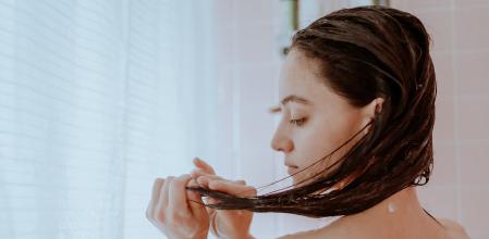 Woman taking a shower and washing her hair at home