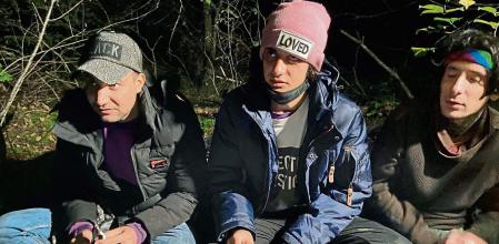 Left to right: Ameer, Hadi, Ali - three Iraqi migrants hiding in a Polish forest near the Polish town of Chelm are pictured shortly after crossing the border from Belarus, on September 30, 2021. - Thousands of migrants, most of them from the Middle East, have crossed or tried to cross into Poland in the last two months in an influx that the EU says is orchestrated by the Belarusian regime. (Photo by Dario THUBURN / AFP) / TO GO WITH AFP STORY by Dario THUBURN
