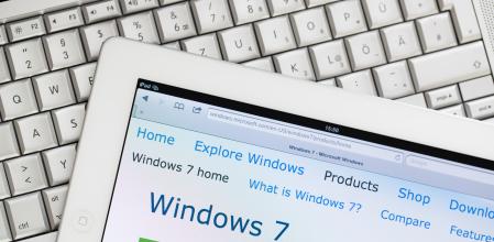 Cape Town, South Africa - December 29, 2011: iPad 2 with Microsoft Windows 7 website on the screen, lying on an Apple MacBook Pro.