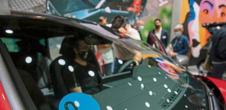 AMBIENTE DE VISITANTES EN EL SALÓN DEL AUTOMOVIL DE BARCELONA. DETELLE DE UN DISTINTIVO DE LA DGT DE UN VEHICULO HIBRIDO SETA LEON DE 0 EMISIONES DE CO2