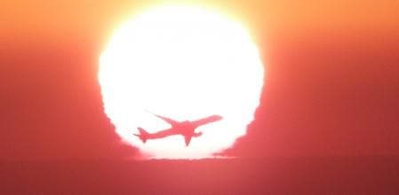 Avión al amanecer bajo el efecto Omega del sol.