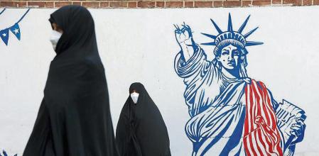 FILE PHOTO: Demonstrators stand in front of a wall of the former U.S. embassy with anti-U.S. murals during the 42nd anniversary of the U.S. expulsion from Iran, in Tehran, Iran November 4, 2021. Majid Asgaripour/WANA (West Asia News Agency) via REUTERS ATTENTION EDITORS - THIS IMAGE HAS BEEN SUPPLIED BY A THIRD PARTY./File Photo