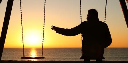 Man alone missing her partner at sunset