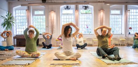 Group of people relaxing on the floor during yoga class; Somatic movement, Awareness through movement, embodiment and Feldenkrais Method Workshop.