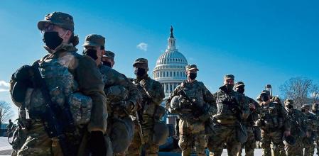 (FILES) In this file photo taken on January 19, 2021, members of the National Guard gather at a security checkpoint near the US Capitol, ahead of the 59th inaugural ceremony for President-elect Joe Biden and Vice President-elect Kamala Harris in Washington, DC. - On January 6, 2021 they descended upon Washington, DC in the thousands, gathering to protest the result of a presidential election they still claim was