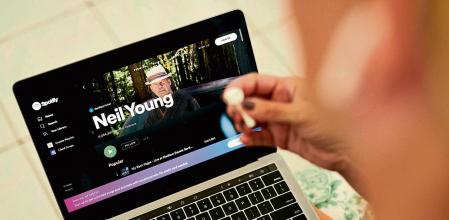 The Neil Young Spotify website page on a laptop computer arranged in Saint Thomas, U.S. Virgin Islands, on Saturday, Jan. 29, 2022. Spotify Technology SA outlined steps it will take to halt the spread of misleading information about Covid-19 on its audio-streaming service in an attempt to quell a growing controversy over its support for the podcast host Joe Rogan. Photographer: Gabby Jones/Bloomberg