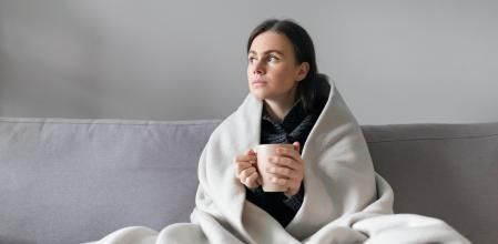 Una joven combate el frío de casa con una manta y una infusión