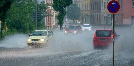 Coches circulando entre grandes charcos de agua