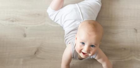 Bebé tumbado boca abajo y con la cabeza erguida