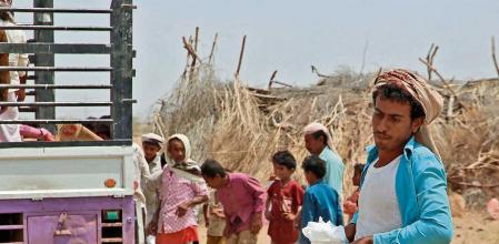 Yemenis displaced by the conflict, receive food aid and supplies to meet their basic needs, at a camp in Hays district in the war-ravaged western province of Hodeidah on March 29, 2022, as food prices have doubled since last year and the fact that Ukraine supplies nearly a third of Yemen's wheat imports has heightened fears of a deepening famine. - The disruption in export flows resulting from Russia's invasion and international sanctions has spurred fears of a global hunger crisis, especially across the Middle East and Africa, where the knock-on effects are already playing out. The toll is most evident in conflict zones such as Yemen, the Arab world's poorest, where a devastating war since 2014 has sparked one of the world's worst humanitarian crises. (Photo by Khaled Ziad / AFP)