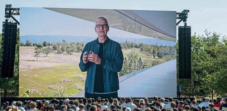 Tim Cook, chief executive officer of Apple Inc., displayed on a projection screen while speaking during the Apple Worldwide Developers Conference at Apple Park campus in Cupertino, California, US, on Monday, June 6, 2022. Apple unveiled a flurry of new software features and services including an updated iPhone lock screen and a pay-later option that pushes the tech giant deeper into finance. Photographer: David Paul Morris/Bloomberg via Getty Images