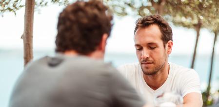 Happy friends catching up over pints in a bar