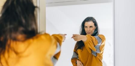 This is me! Portrait of attractive haughty ginger girl in sweater pointing at herself and looking at camera with arrogance, proud and confident in success. studio shot isolated on pink background