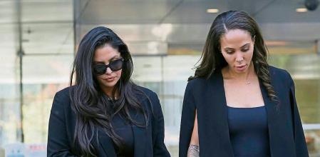 Vanessa Bryant, left, the widow of the late Kobe Bryant, holds hands with friend, Sydney Leroux as they leave a federal courthouse in Los Angeles Friday, Aug. 19, 2022. Vanessa Bryant testified Friday that she was only beginning to grieve the loss of her husband, basketball star Kobe Bryant, and their 13-year-old daughter Gianna when she was faced with the fresh horror of learning that sheriff's deputies and firefighters had shot and shared photos of their bodies at the site of the helicopter crash that killed them. (AP Photo/Damian Dovarganes)