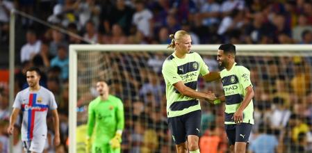 BARCELONA, SPAIN - AUGUST 24: Riyad Mahrez of Manchester City celebrates with Erling Haaland of Manchester City after scoring their team's third goal during the friendly match between FC Barcelona and Manchester City at Camp Nou on August 24, 2022 in Barcelona, Spain. (Photo by David Ramos/Getty Images)