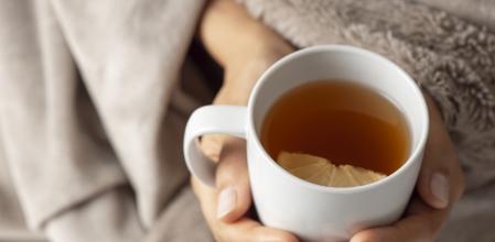 Woman holding a cup of tea.