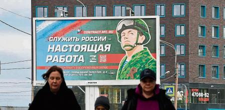 (FILES) In this file photo taken on September 20, 2022 a billboard promoting contract army service with an image of a serviceman and the slogan reading 