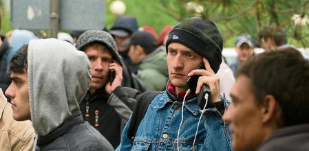 Russians, mostly men, lineup to get a Kazakh registration after crossing the border into Kazakhstan from the Mariinsky border crossing, about 400 km (250 miles) south of Chelyabinsk, in Russia, to Kazakhstan's town Uralsk, 1400 km east of Astana, the capital of Kazakhstan, Wednesday, Sept. 28, 2022. Russians have crossed into Kazakhstan in the week since President Vladimir Putin announced a partial mobilization of reservists to fight in Ukraine, Kazakh officials said Tuesday, as men seeking to avoid the call-up continued to flee by land and air into neighboring countries. (AP Photo/Denis Spiridonov)