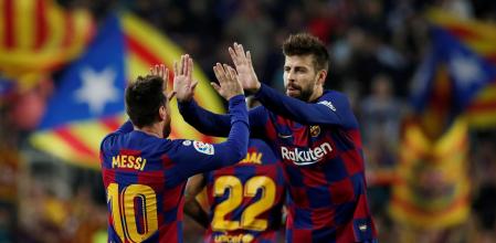 FILE PHOTO: Soccer Football - La Liga Santander - FC Barcelona v Real Valladolid - Camp Nou, Barcelona, Spain - October 29, 2019  Barcelona's Lionel Messi celebrates scoring their third goal with Gerard Pique   REUTERS/Albert Gea/File Photo