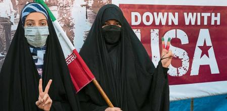 Iranian women flash a victory sign during annual demonstration in front of the former U.S. Embassy in Tehran, Iran, Friday, Nov. 4, 2022. Iran on Friday marked the 1979 takeover of the U.S. Embassy in Tehran as its theocracy faces nationwide protests after the death of a 22-year-old woman earlier arrested by the country's morality police. (AP Photo/Vahid Salemi)