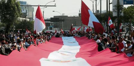 People carry a Peruvian flag, during a protest against the government of Peru's President Pedro Castillo, in Lima, Peru November 5, 2022. REUTERS/Sebastian Castaneda