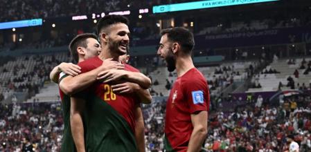 Portugal's forward #26 Goncalo Ramos (front) celebrates with teammates after he scored his team's third goal during the Qatar 2022 World Cup round of 16 football match between Portugal and Switzerland at Lusail Stadium in Lusail, north of Doha on December 6, 2022. (Photo by Fabrice COFFRINI / AFP)