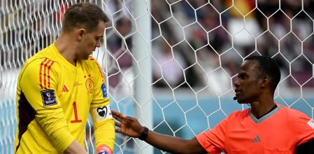 TOPSHOT - An assistant referee checks on the the captain-s armband on Germany's goalkeeper #01 Manuel Neuer ahead of the Qatar 2022 World Cup Group E football match between Germany and Japan at the Khalifa International Stadium in Doha on November 23, 2022. (Photo by INA FASSBENDER / AFP)