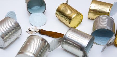 open cans are scattered on a white background