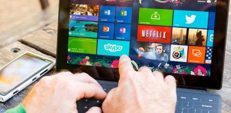 Ankara, Turkey - September 8, 2013:  Man using his surface tablet at the park. Microsoft Surface is a series of tablets designed and marketed by Microsoft