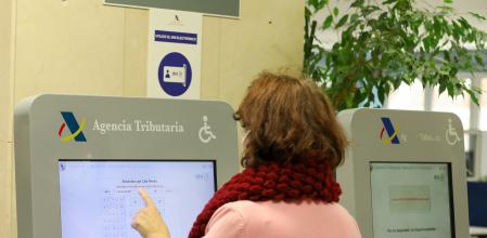 Una mujer recoge su turno en una oficina de la Agencia Tributaria