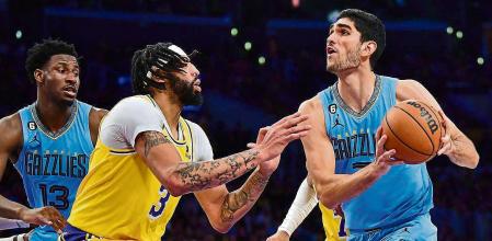 Mar 7, 2023; Los Angeles, California, USA; Memphis Grizzlies forward Santi Aldama (7) moves to the basket against Los Angeles Lakers forward Anthony Davis (3) during the second half at Crypto.com Arena. Mandatory Credit: Gary A. Vasquez-USA TODAY Sports