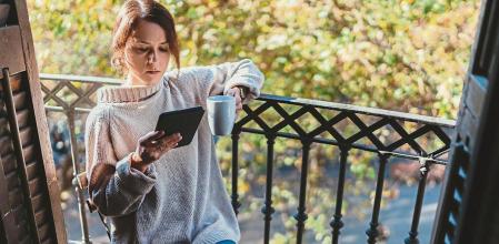 Girl drinking her morning coffee on the terrace in Barcelona