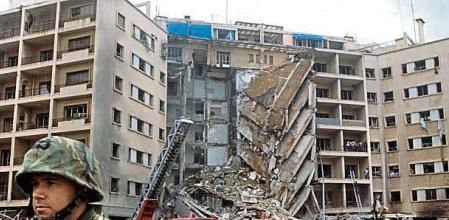 An American Marine Second Lieutenant stands with his back to rescue workers swarming the ruins of the American embassy after a suicide bomber attacked killing 63, including 17 Americans among them CIA station chief Robert Ames, Beirut, April 18, 1983. The US Marines were there as part of the failed Multinational Force peacekeeping intervention in the Lebanese Civil War. FDM-1349-8. (Photo by Francoise De Mulder/Roger Viollet via Getty Images)