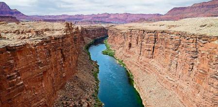 FILE - The Colorado River flows in Lees Ferry, Ariz., on May 29, 2021. Arizona, California and Nevada on Monday, May 22, 2023, proposed a plan to reduce their water use from the drought-stricken Colorado River over the next three years, a potential breakthrough in a year-long stalemate that pitted Western states against one another. (AP Photo/Ross D. Franklin, File)