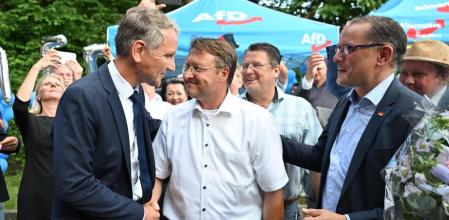 (L-R) Bjoern Hoecke, Robert Sesselmann and Tino Chrupalla of the far-right Alternative for Germany (AfD) party celebrate at an election event in Sonneberg, eastern Germany on June 25, 2023. Germany's far-right AfD won its first district election on June 25, 2023, in a further boost to the anti-immigration party as it surges to record-highs in opinion polls. Robert Sesselmann, a lawyer and regional lawmaker, won a closely-watched run-off vote for district administrator in Sonneberg in the central state of Thuringia, near the border with Bavaria. (Photo by Martin Schutt / dpa / AFP) / Germany OUT
